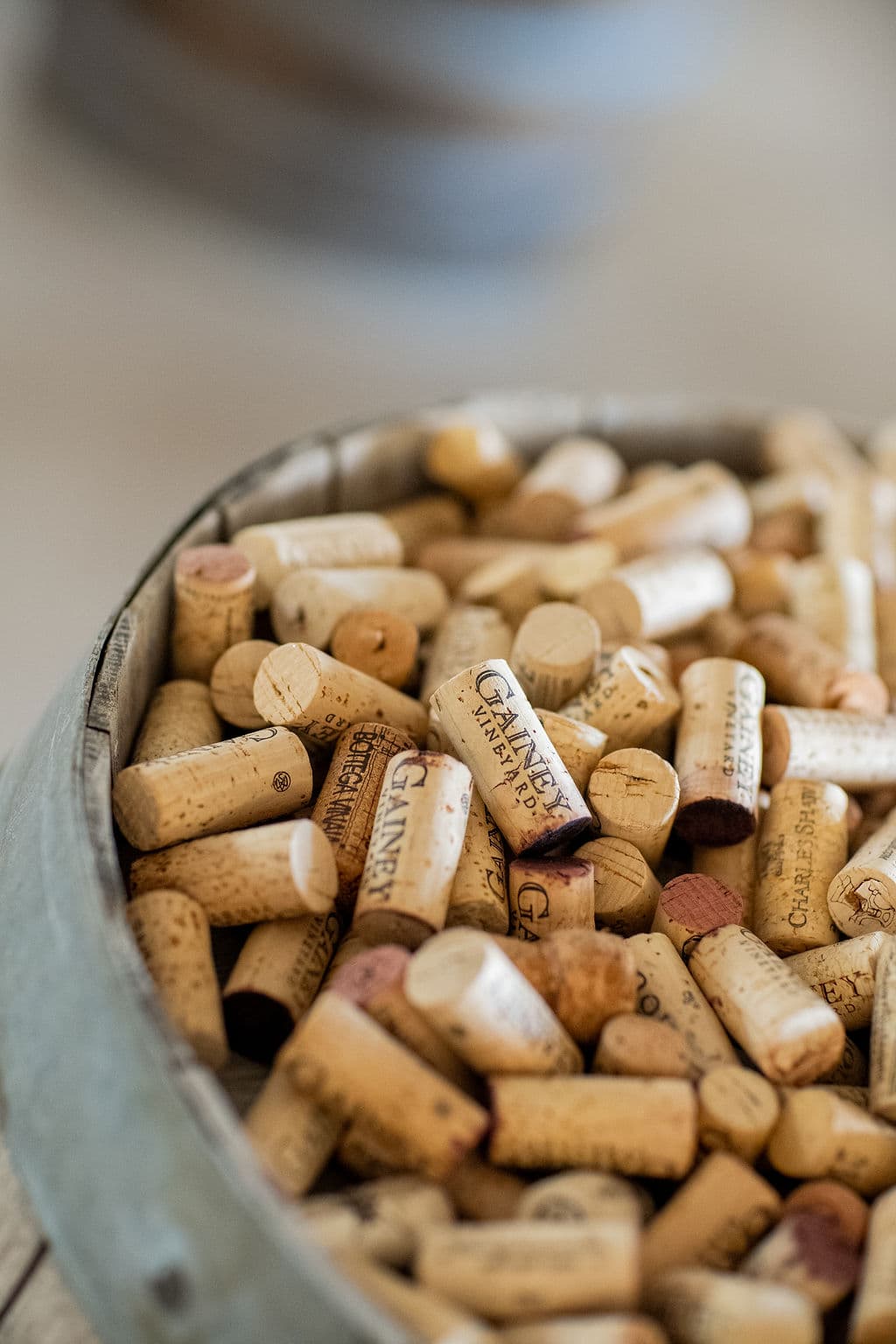 A collection of wine corks gathered in a rustic container.